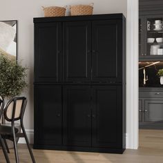 a dining room table and chairs with black cabinets