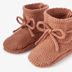 These comfortable hand-crocheted booties are the perfect, soft-sided shoe for every little one's tiny toes. The soft knitting feels dreamy on those sensitive baby feet. These adorable, cotton garter knit booties blend fashion and comfort for every little adventurer. 100% cotton Hand crocheted Fits 0-6 months Adjustable drawstring bow Damp wipe to clean Cozy Soft Booties With Round Toe, Cozy Knitted Booties With Round Toe, Comfortable Winter Booties With Soft Sole, Cozy Winter Booties With Soft Sole, Crochet Booties With Round Toe For Winter, Cozy Hand Knitted Round Toe Booties, Casual Crochet Booties With Round Toe, Casual Hand Knitted Round Toe Booties, Cute Hand Knitted Round Toe Booties