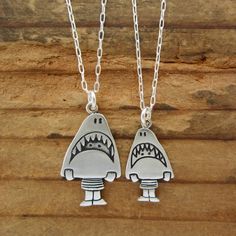 This cute set is a fun gift for your friends with kids. They are made from sterling silver, the mom measures 3/4" high and the daughter 1/2" high.  The daughter hangs from a 16" silver-plated cable chain and the mom hangs from an 18" silver-plated cable chain.If you have two kids:https://www.etsy.com/listing/87244713/two-kids-famiy-necklaceTo see the larger necklace click here:https://www.etsy.com/listing/517944382/sterling-shark-girl-necklace-cute-silverTo see the smaller necklace click here:ht Playful Silver Charm Necklaces, Fun Charm Necklaces For Gifts, Playful Silver Jewelry For Friendship, Personalized Sterling Silver Necklaces For Friendship, Cute Nickel-free Charm Necklace For Friendship, Cute Silver Sterling Silver Charm Necklaces, Personalized Novelty Jewelry For Mother's Day, Cute Silver Charm Necklaces, Fun Silver Jewelry For Friendship