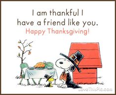 a happy thanksgiving card with a cartoon character and a dog in front of a table