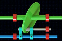 a green object with red and blue bars attached to it's sides, in front of a black background