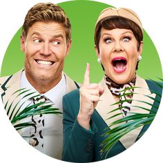 two people are making funny faces while pointing at the camera with their fingers and palm leaves in front of them