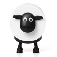 a black and white sheep figurine with eyes on it's head, standing in front of a white background