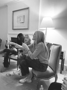 black and white photograph of three women sitting in a living room