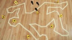 a wooden floor with yellow tape and numbers on it that have been cut into the shape of a horse