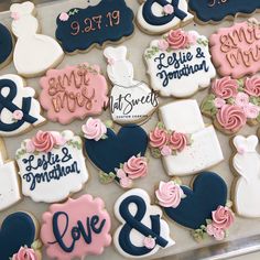 decorated cookies are arranged on a tray for wedding guests to enjoy and share their special occasion