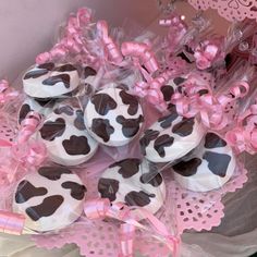 chocolate covered donuts in pink and black polka dots on a lace doily with bows