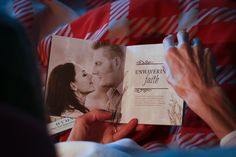 a man and woman are holding an open wedding book with the couple's photo on it