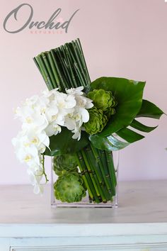 a vase filled with white flowers on top of a table