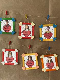 four frames are hanging on a string with clothes pins attached to them that have pictures of children's faces and hearts