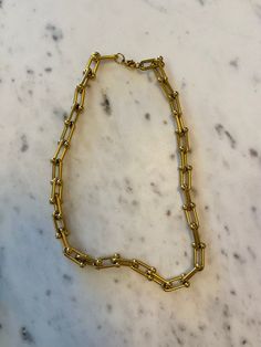 Elevate your style with this 18K gold plated stainless steel u-shaped link chain necklace. The necklace is hypoallergenic, waterproof, fade-resistant, and tarnish-resistant, ensuring its beauty lasts for years. With proper care, the gold plating will remain radiant for at least 2 years. Perfect for everyday wear or special occasions. 15.8" L + extender. Everyday Tarnish-resistant Paperclip Chain Necklace, Trendy Tarnish Resistant Link Chain Necklace, Trendy Tarnish-resistant Chain Link Necklace, Gold Stainless Steel Chunky Chain Necklace, Stainless Steel Paperclip Chain Necklace, Everyday Stainless Steel Paperclip Chain Necklace, Stainless Steel Gold Chain Necklace For Everyday, Everyday Stainless Steel Necklace With Gold Chain, Minimalist Stainless Steel Necklace