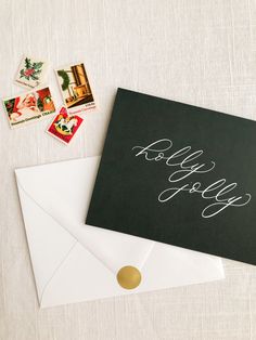 an envelope and some stamps on top of a piece of paper with the word hello holly written in cursive writing