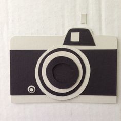 an image of a black and white camera on a piece of paper that has been cut out