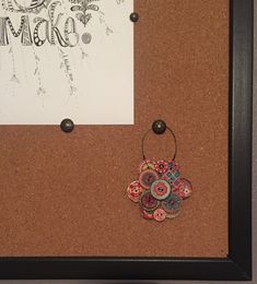 a cork board with some buttons on it