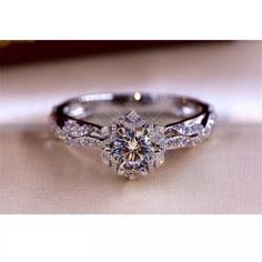 a diamond engagement ring sitting on top of a table