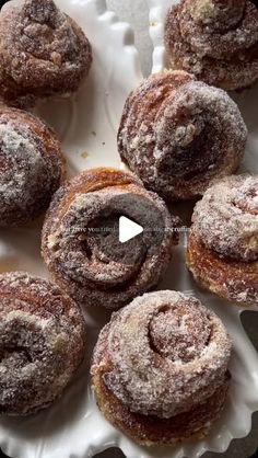 powdered sugar donuts on a white plate