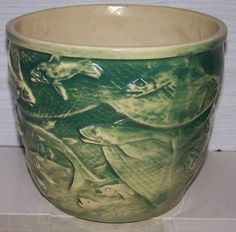 a green and white bowl sitting on top of a counter