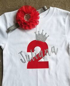 a white shirt with the number two and a red flower