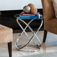 a glass table with books on it and a chair in the backgroung