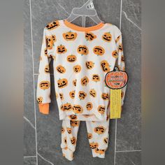 Get Your Little One Ready For Halloween With This Adorable 2-Piece Pajama Set From Pj's & Pumpkins. The Long Sleeve Top And Pants Are Perfect For The Cooler Seasons Of Fall And Inter, And Feature A Fun Pumpkin Pattern That Is Sure To Delight Any Little Trick-Or-Treat. The Pullover Closure Makes It Easy To Dress Your Baby, And The Beige Color Is Neutral Enough To Pair With Any Outfit. This Set Is Available In Size 12 Months And Is Suitable For Both Baby Boys And Girls. It Is Made In Bangladesh Wi Fun Pumpkins, Kids Pjs, Ready For Halloween, Halloween Party Themes, Month Colors, Pumpkin Pattern, Kids Pajamas, Halloween Pumpkin, Beige Color