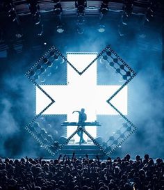 a man standing on top of a stage in front of a crowd