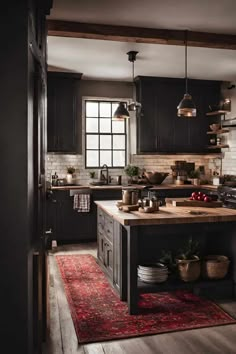 a kitchen with black cabinets and an island in the middle, surrounded by potted plants