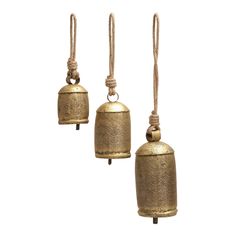 three brass bell ornaments hanging from ropes