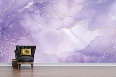 a chair sitting in front of a purple and gold wall