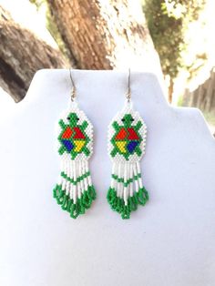 These Native Beaded Turtle Earrings are very Cute and fun to wear. A Great Gift for anyone. They are 3 1/2 in. long with gold plated ear wires, can be changed to post or clips. They are made with White, Green, Red, Orange, Yellow and Black Delica Beads. If you have any Questions just ask. Thanks for looking. Beading Patterns Free Native American, Indigenous Crafts, Beaded Turtle, Earrings 2022, Native American Beadwork Patterns, Native Beading Patterns, Wire Wrapped Jewelry Diy, Southwestern Boho, Beadwork Designs