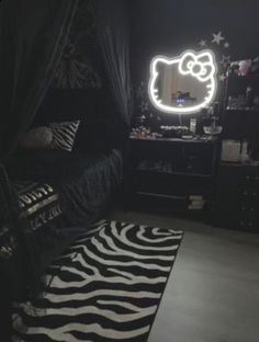 a bed room with a zebra print rug and a hello kitty light on the wall