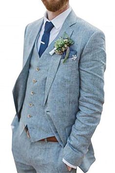 a man with a beard wearing a blue suit and flower boutonniere on his lapel