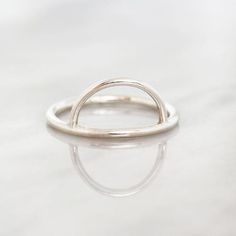 Silver Half Moon Stacking Ring. This versatile ring is a stacking must-have. It makes a frame to highlight anything that you stack it with. The sterling silver band measures 1.6mm thick, and the half moon circle is approximately 15mm wide at the widest point and 9mm tall. I forge each ring individually, made to order in US rings sizes. The ring is made of Argentium Silver, which is a newer silver alloy similar to Sterling, but much more tarnish resistant. Modern Handmade Stackable Rings For Everyday, Silver Hoop Rings For Everyday, Adjustable Hoop Rings In Minimalist Style, Adjustable Hoop Minimalist Rings, Minimalist Adjustable Hoop Rings, Minimalist Silver Stackable Circle Rings, Minimalist Circle Stackable Promise Rings, Minimalist Stackable Open Circle Rings As Gift, Modern Stackable Rings With Open Circle For Everyday