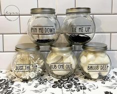 four glass jars with labels on them that read, pin me down, the me up, rub one out and balls deep