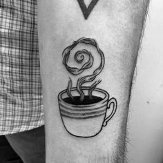 a black and white photo of a coffee cup tattoo