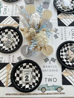 a table topped with black and white checkered plates