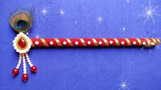 a red and white feathered stick on a blue background