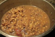 a pot filled with lots of beans on top of a stove