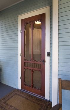 a wooden door on the side of a house with a bench in front of it