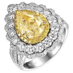 Presenting a truly exceptional piece, this Yellow Diamond Ring is an exquisite expression of luxury and beauty. The centerpiece of this ring is a remarkable IGI certified 2.51 carat VS1 N color yellow diamond, radiating a captivating hue and a brilliant sparkle. With a "good" grade for both polish and symmetry, and no fluorescence, this diamond showcases exceptional craftsmanship and quality. Surrounding the center stone is a halo of natural fancy yellow diamonds, totaling 0.15 carats, enhancing