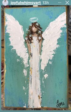 an angel painted on a piece of wood