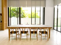 a dining room table and chairs with sliding glass doors