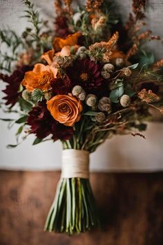 a bouquet of flowers sitting on top of a wooden table