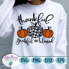 a woman wearing a white shirt with pumpkins on it and the words, thank grateful in