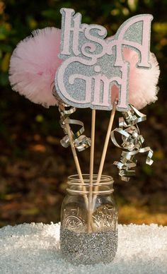 a mason jar filled with pink and silver decorations