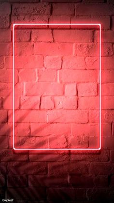 a red neon frame on a brick wall in the shape of a square, against a dark background