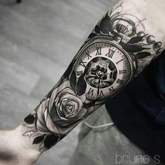 a man's arm with a clock and roses tattoo on it