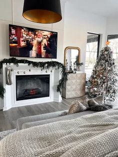 a living room filled with furniture and a flat screen tv mounted on the wall above a fire place