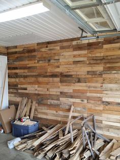 a pile of wood sitting next to a white door in a room filled with wooden planks