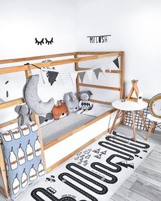 a child's bedroom with black and white decor on the walls, wooden bunk bed frame