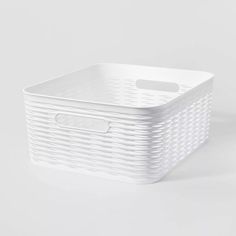 a white plastic basket with handles